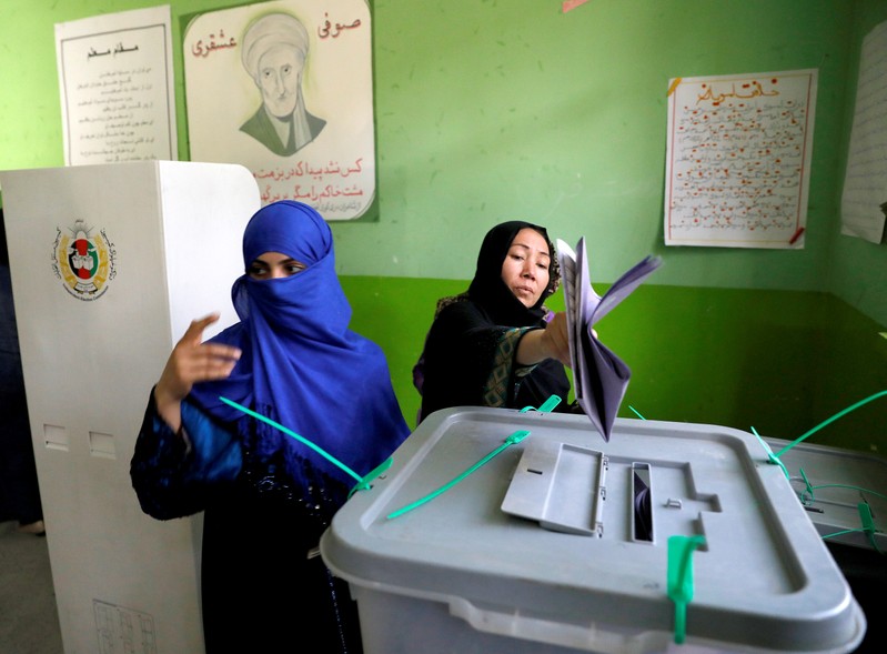 Afghan women cast their votes during parliamentary elections at a polling station in Kabul, Afghanistan