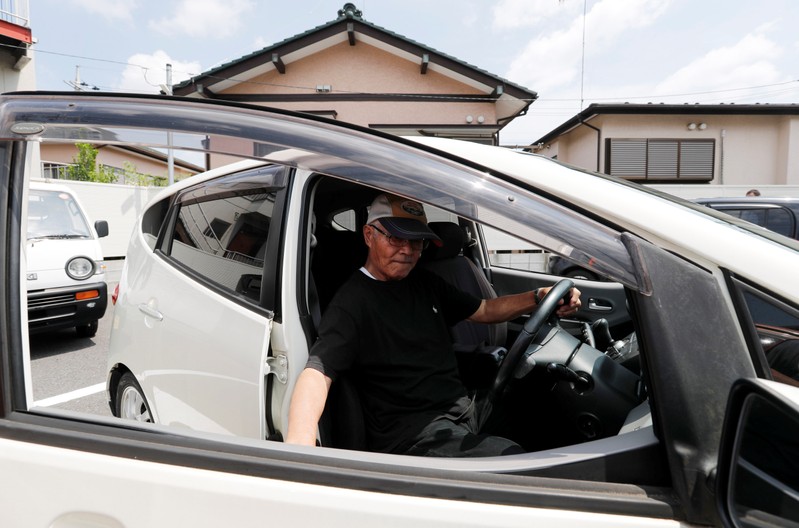 Horie Miho drives his minicar after visiting a minicar dealership in Yamato
