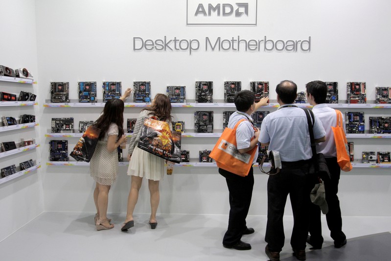 FILE PHOTO: Visitors look at motherboards being displayed at the AMD booth during the 2012 Computex exhibition at the TWTC Nangang exhibition hall in Taipei
