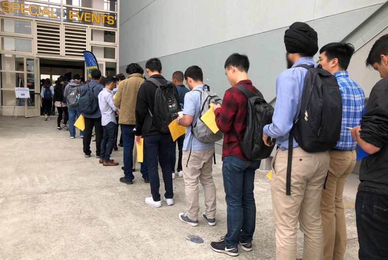 Students wait in line to enter the University of California, Berkeley's electrical engineering and computer sciences career fair in Berkeley