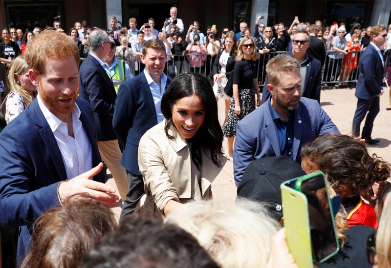 Britain's Prince Harry and wife Meghan, Duchess of Sussex greet members of the public during a visit at the Sydney Opera House in Sydney