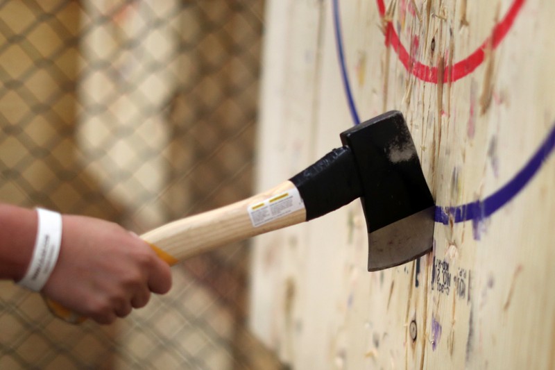 Faith Aids participates in axe throwing, a sport that started in the Canadian backwoods and is growing in popularity in U.S. cities, at LA Ax in North Hollywood, Los Angeles