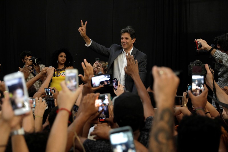 Presidential candidate Fernando Haddad greets supporters during a rally in Mare slums complex in Rio de Janeiro
