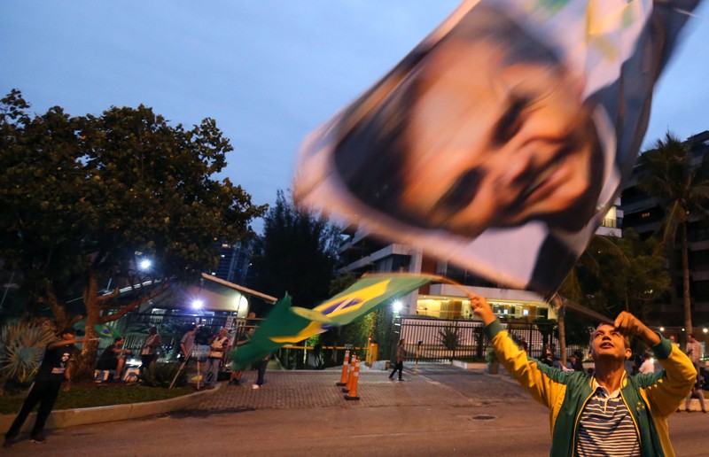 A supporter of Brazilian presidential candidate Jair Bolsonaro is seen in front of the Bolsonaro's condominium in Rio de Janeiro