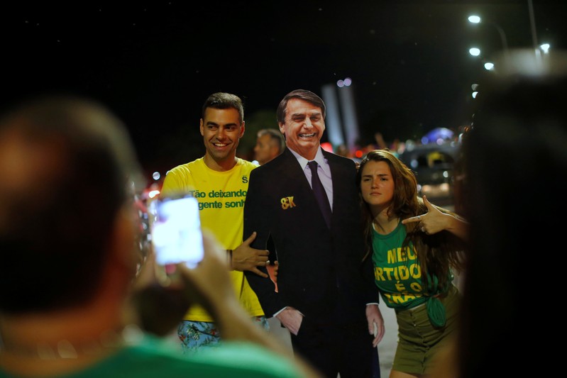 Supporters of Jair Bolsonaro react after Bolsonaro won the presidential race, in Brasilia