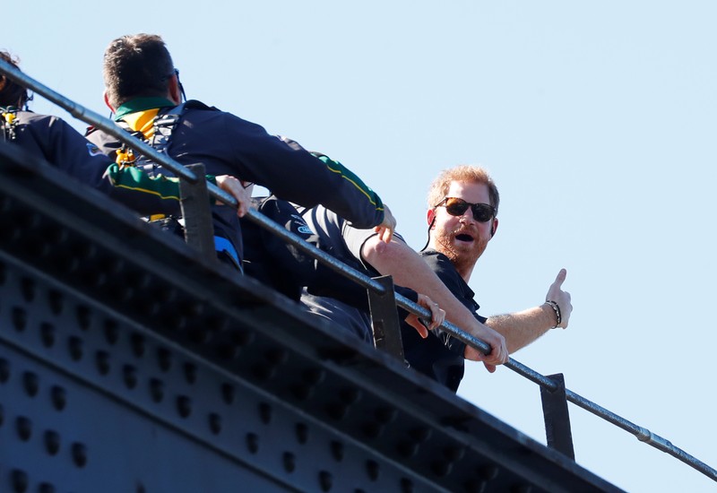Britain's Prince Harry gives a thumbs-up as he climbs the Sydney Harbour Bridge in Sydney