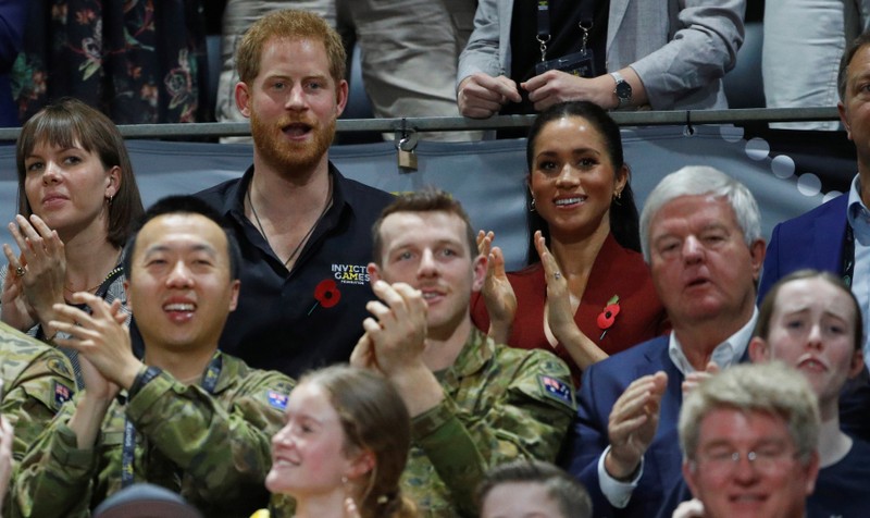 Britain's Prince Harry and Meghan, Duchess of Sussex, react as they watch the Invictus Games Sydney 2018 wheelchair basketball gold medal match at Quaycentre in Sydney, Australia