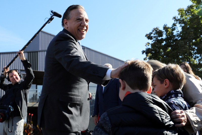 Coalition Avenir Quebec (CAQ) party leader Francois Legault greets children after casting his ballot in L'Assomption