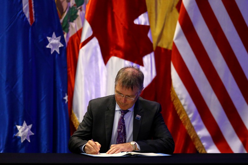 New Zealand's Minister for Trade and Export Growth David Parker signs the Trans-Pacific Partnership (TPP) trade deal, in Santiago