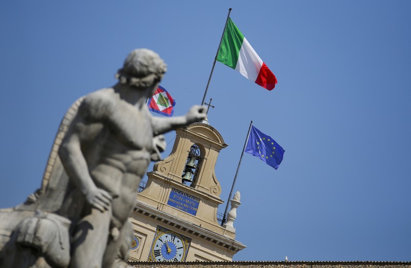 The Italian national flag flutters atop of the Quirinale presidential palace in Rome