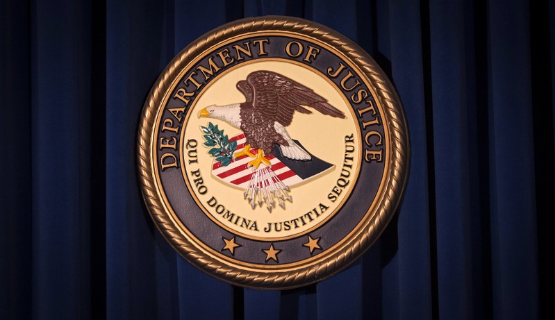 FILE PHOTO: The DOJ logo is pictured on a wall after a news conference in New York