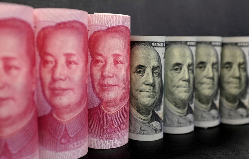 FILE PHOTO: U.S. 100 dollar banknotes and Chinese 100 yuan banknotes are seen in this picture illustration in Beijing
