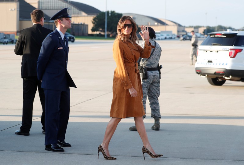 U.S. first lady Melania Trump waves while departing Washington for a tour of several African countries from Joint Base Andrews, Maryland