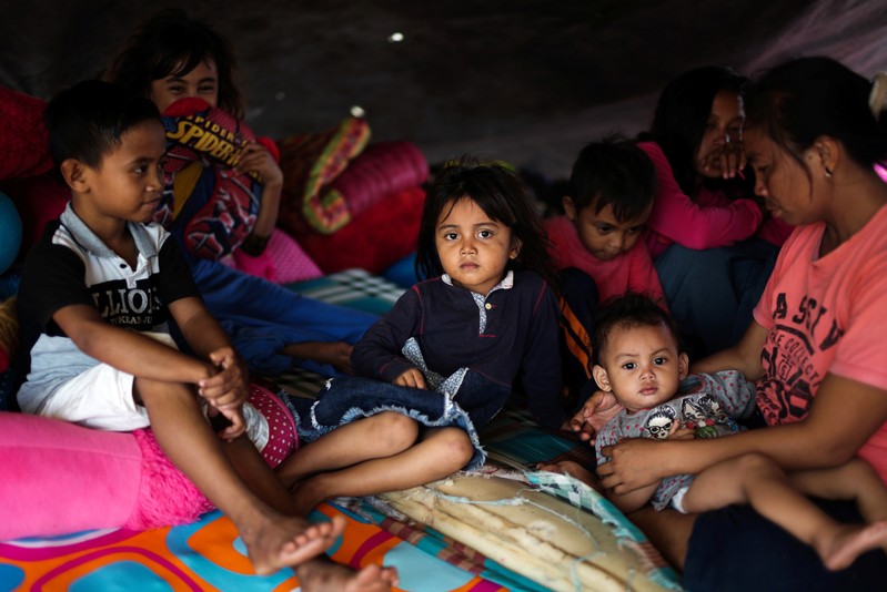 A family affected by the earthquake and tsunami is pictured at a temporary shelter in Donggala