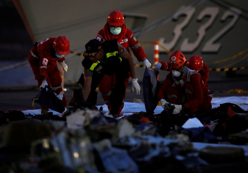 Rescue workers of the crashed Lion Air flight JT610 sort out newly recovered debris at Tanjung Priok port in Jakarta