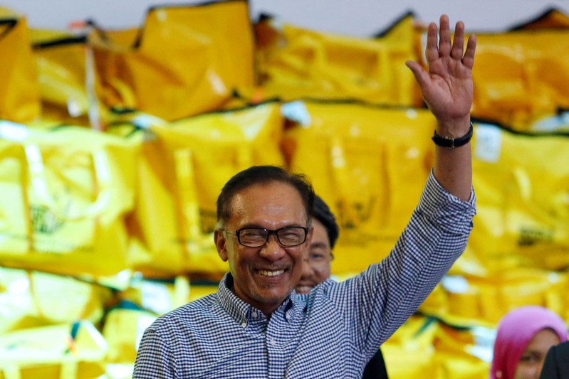 Malaysia's politician Anwar Ibrahim celebrates after winning the by-election in Port Dickson