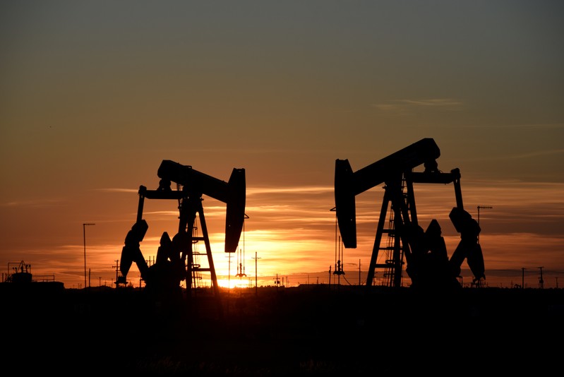 FILE PHOTO: Pump jacks operate at sunset in an oilfield in Midland, Texas
