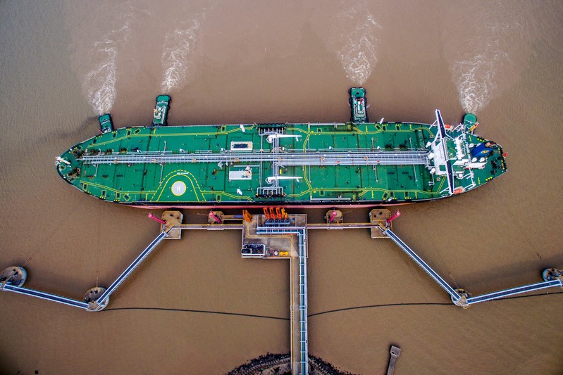 FILE PHOTO: Oil tanker unloads crude oil at a crude oil terminal in Zhoushan