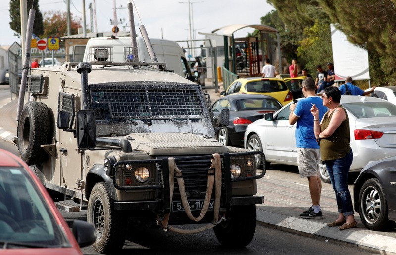 Israeli military vehicle is seen at the entrance of Barkan industrial park that is adjacent to the settlement of Barkan following a shooting attack, in the occupied West Bank