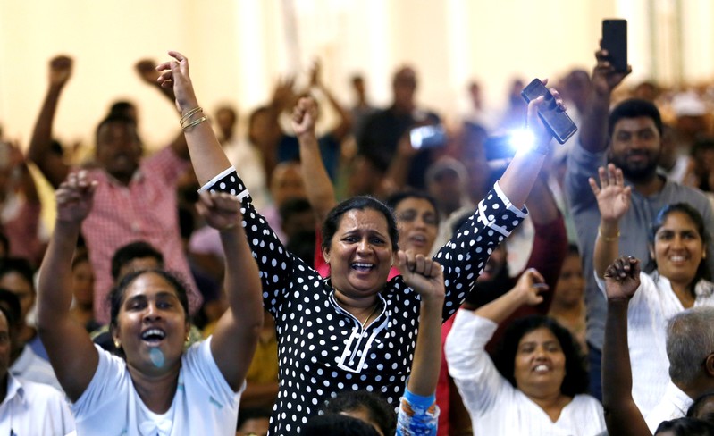 Supporters of Sri Lanka's ousted Prime Minister Ranil Wickremesinghe shout inside the Prime Minister office in Colombo