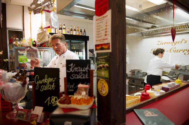 FILE PHOTO: Owner Mario Ziervogel and his wife Viola sell Currywurst at Ziervogels Kult Curry in Berlin