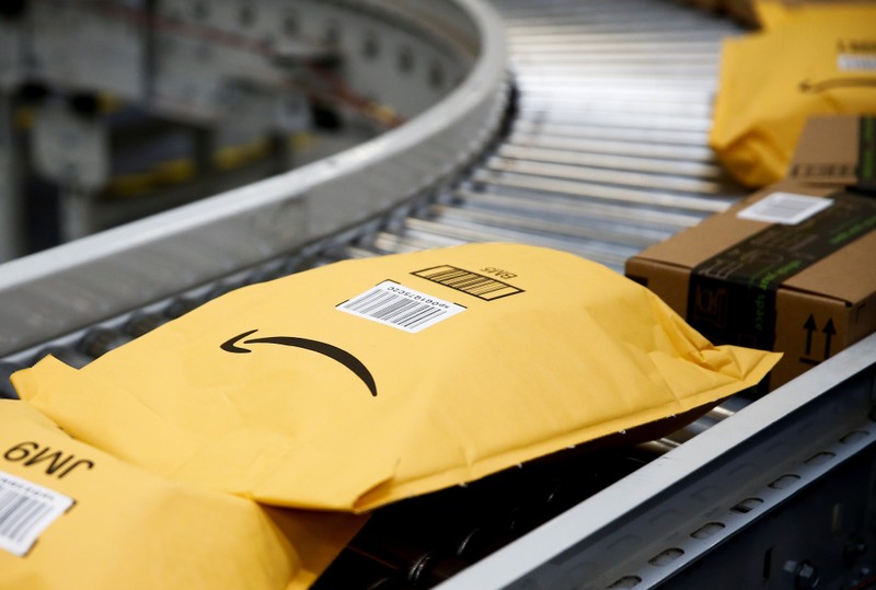 Packages go on an automated conveyor line to be scanned, weighed and labeled at the Amazon fulfillment center in Kent