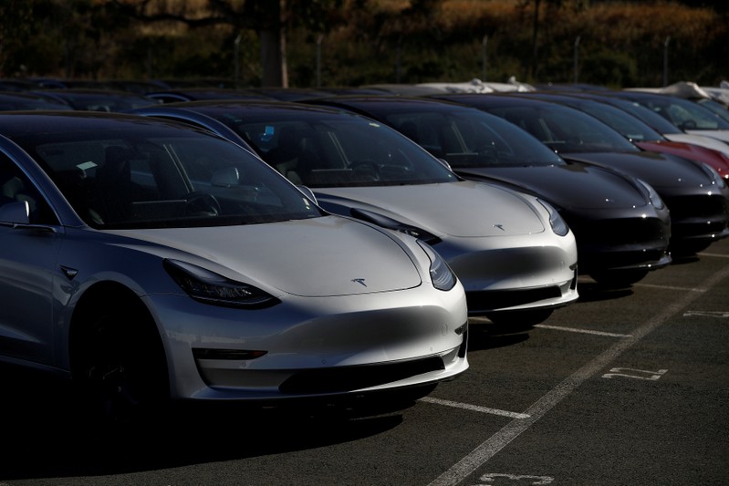 FILE PHOTO: A row of new Tesla Model 3 electric vehicles at a parking lot in Richmond California