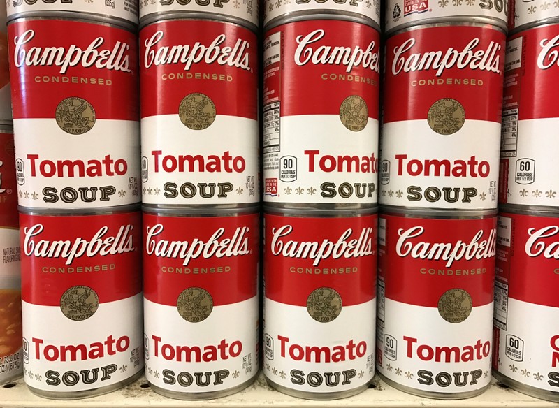 FILE PHOTO: Tins of Campbell's Tomato Soup are seen on a supermarket shelf in Seattle