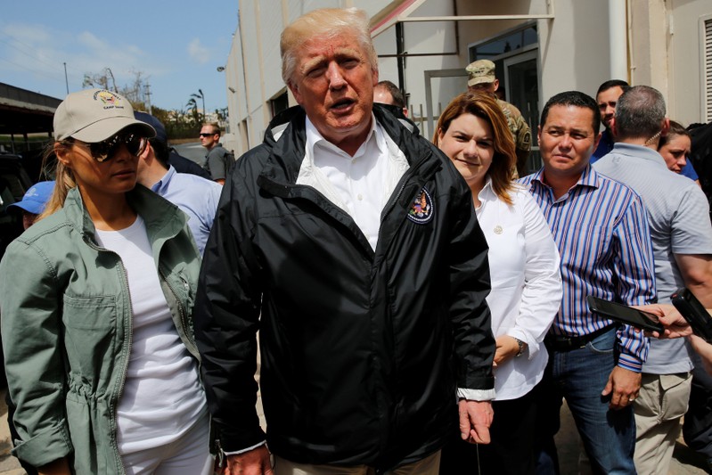 U.S. President Donald Trump stops to speak with reporters outside a hurricane relief distribution center at Calvary Chapel in San Juan