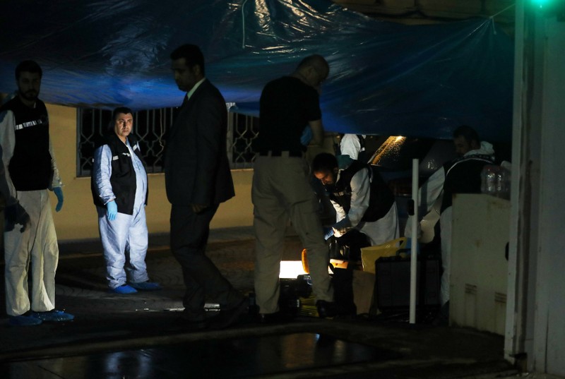 Turkish police forensic experts and Saudi officials are seen at the backyard of Saudi Arabia's consulate in Istanbul