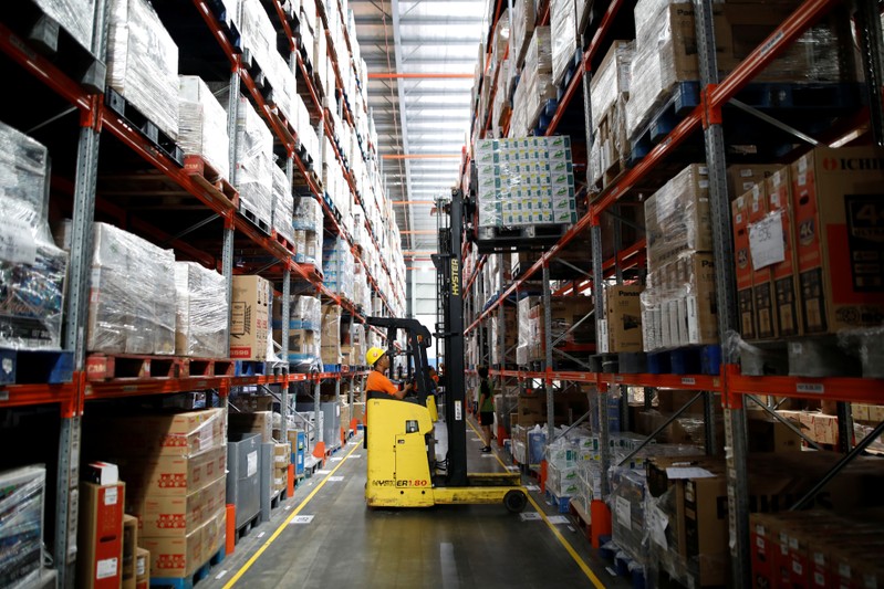 A worker uses a forklift to collect items at online retailer Lazada's warehouse in Depok