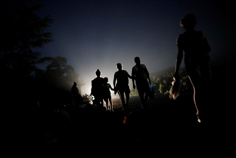 Migrants, part of a caravan of thousands from Central America en route to the United States, make their way to Pijijiapan from Mapastepec