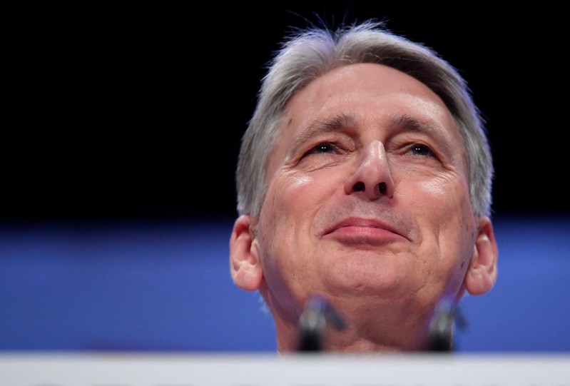 Britain's Chancellor of the Exchequer Philip Hammond walks on to the stage before delivering his keynote address at the Conservative Party Conference in Birmingham