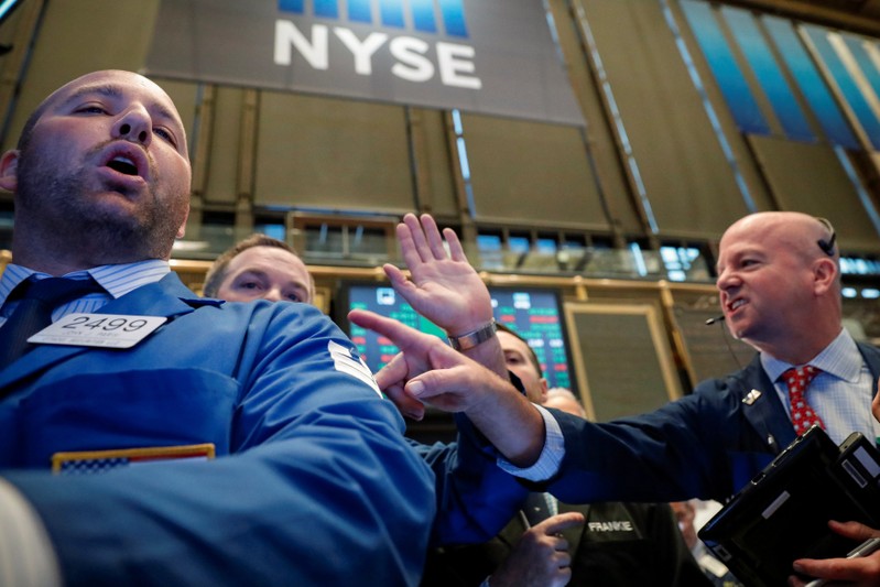 FILE PHOTO: Traders work on the floor of the NYSE in New York