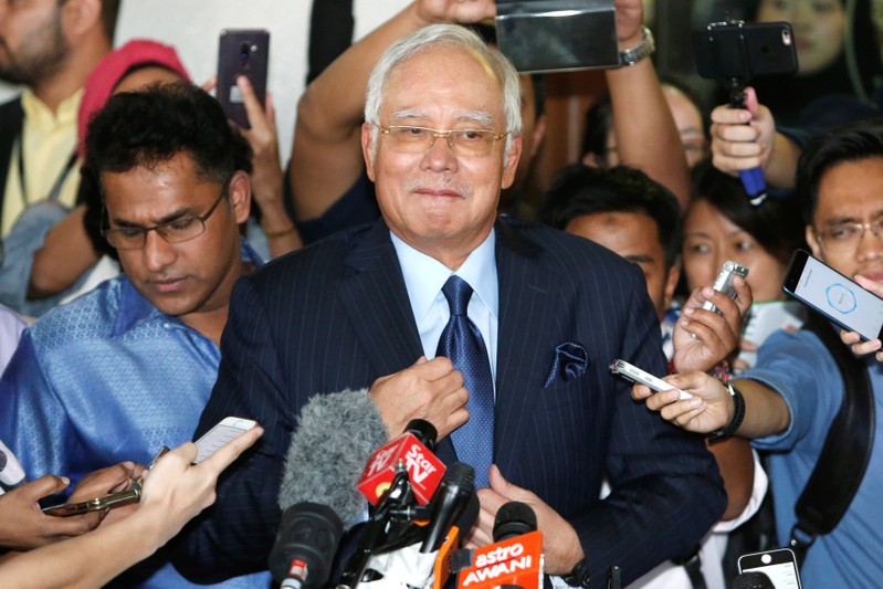 Malaysia's former Prime Minister Najib Razak prepares to speak to journalists as he leaves a court in Kuala Lumpur