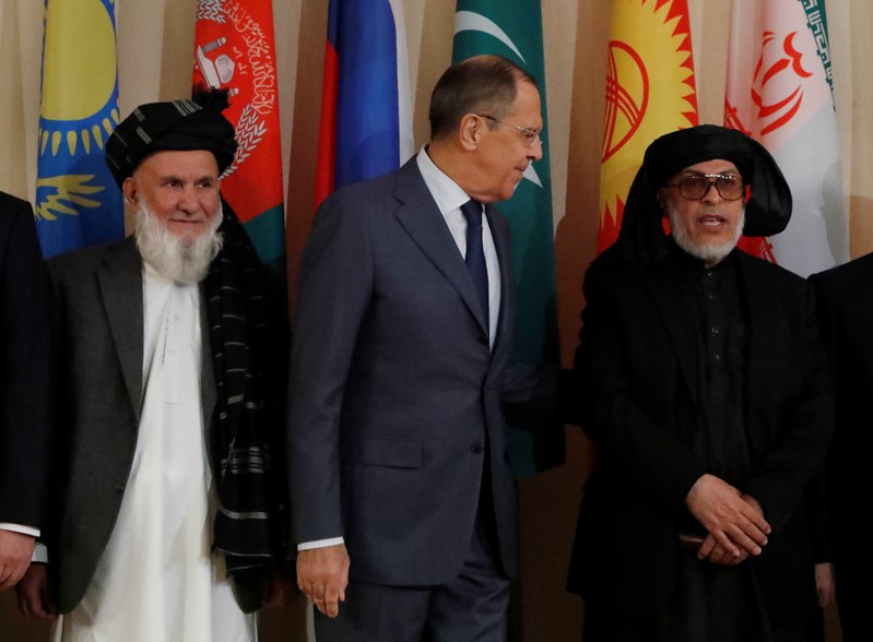 Head of Afghanistan delegation Din Mohammad, Russian Foreign Minister Lavrov and head of Taliban delegation Stanakzai pose for a family photo during the multilateral peace talks on Afghanistan in Moscow