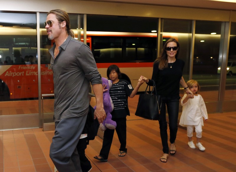 Hollywood actors Brad Pitt and actress Angelina Jolie arrive with their children at Haneda international airport in Tokyo