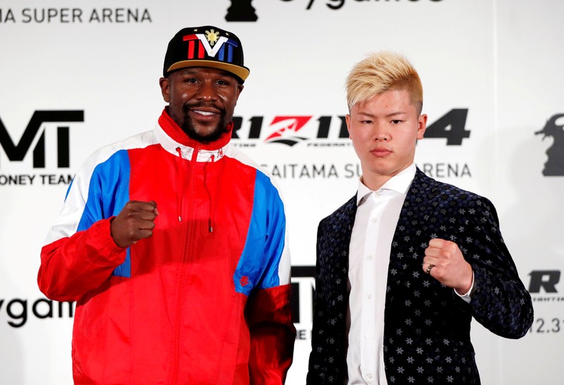 FILE PHOTO: Boxer Floyd Mayweather Jr. of the U.S. poses for a photograph with his opponent Tenshin Nasukawa during a news conference in Tokyo