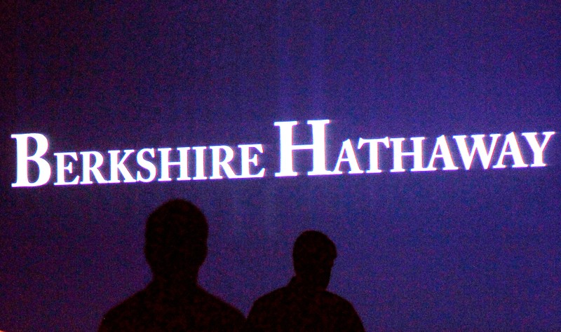 FILE PHOTO: File photo of Berkshire Hathaway shareholders walking by a video screen at the company's annual meeting in Omaha