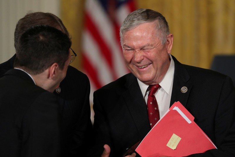 FILE PHOTO: U.S. Representative Dana Rohrabacher speaks with fellow attendees before President Donald Trump's remarks at a meeting of the National Space Council at the White House in Washington