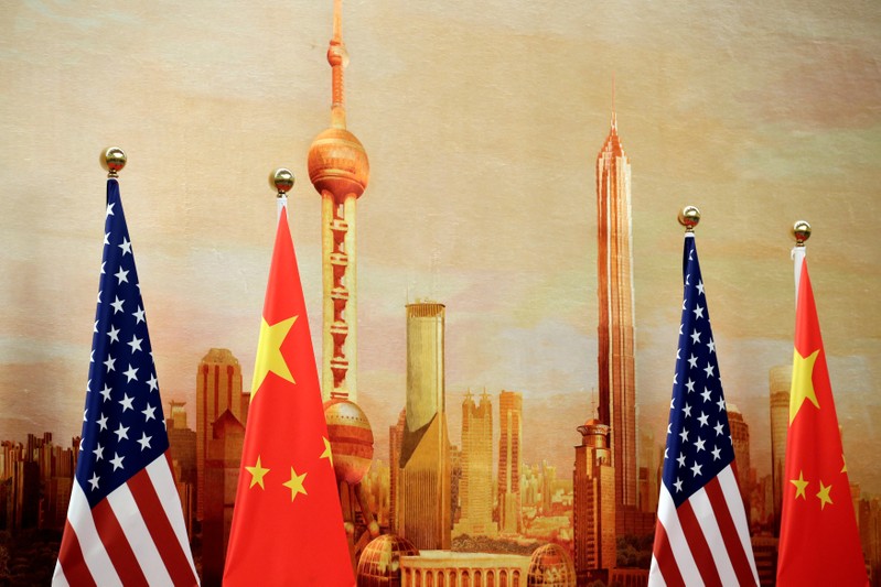 U.S. and Chinese flags are placed for a joint news conference in Beijing