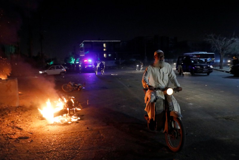 A man rides a motorbike during a protest, after paramilitary and police forces disperse the supporters of the Tehrik-e-Labaik Pakistan Islamist political party, in Karachi