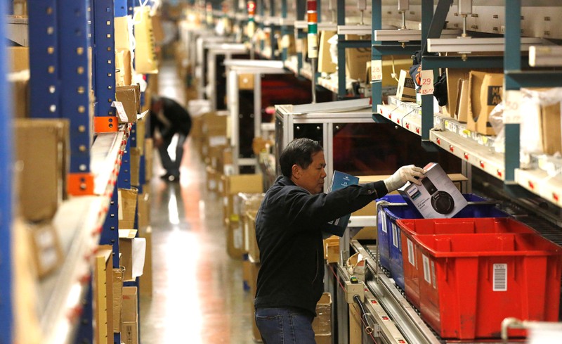 Employees prepare items for shipping at the Newegg warehouse on Cyber Monday in City of Industry