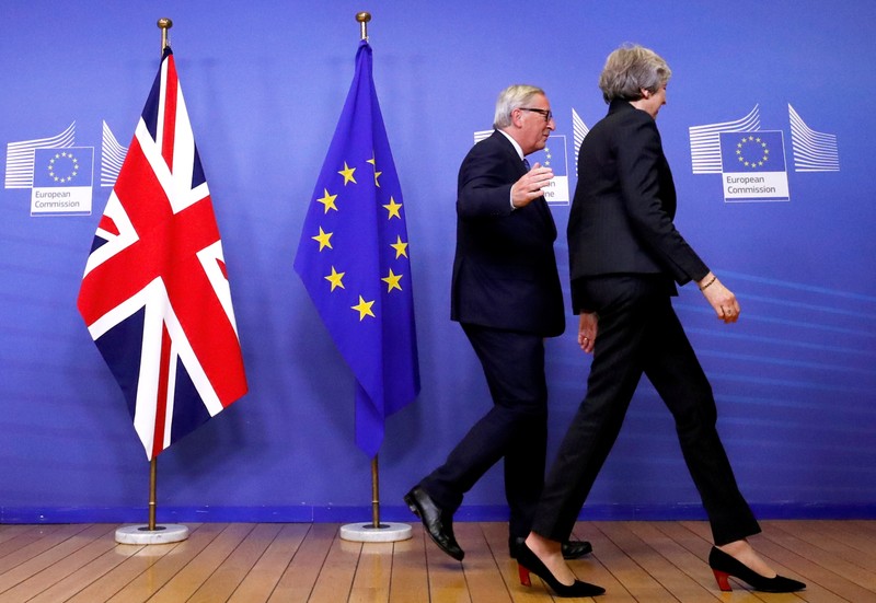 British Prime Minister Theresa May and European Commission President Jean-Claude Juncker leave to discuss draft agreements on Brexit, at the EC headquarters in Brussels