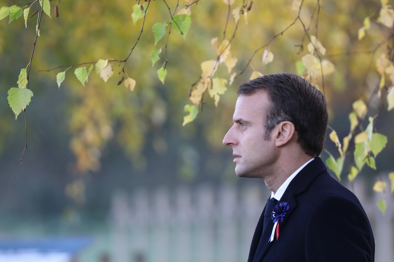 French President Emmanuel Macron arrives to pay his respect by the tomb of Lieutenant Robert Porchon, brother-in-arms of French writer Maurice Genevoix, at the Trottoir necropolis in Les Eparges
