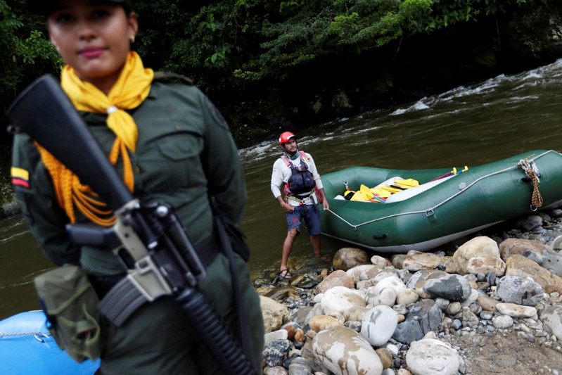 A police woman escorts an inflatable raft in Miravalle
