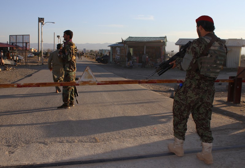 Afghan National Army (ANA) soldiers stand guard at the gate of an army base after a suicide blast in Khost province, Afghanistan