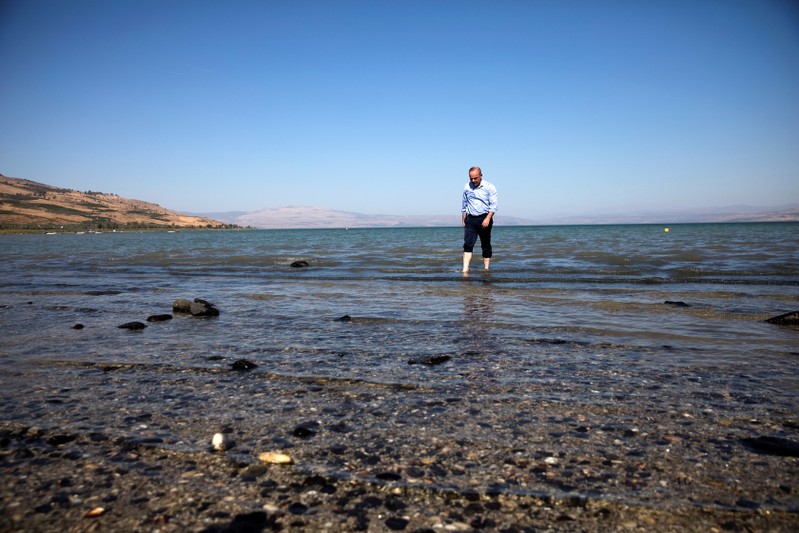 Israel's Minister of Energy Steinitz walks in the Sea of Galilee in northern Israel