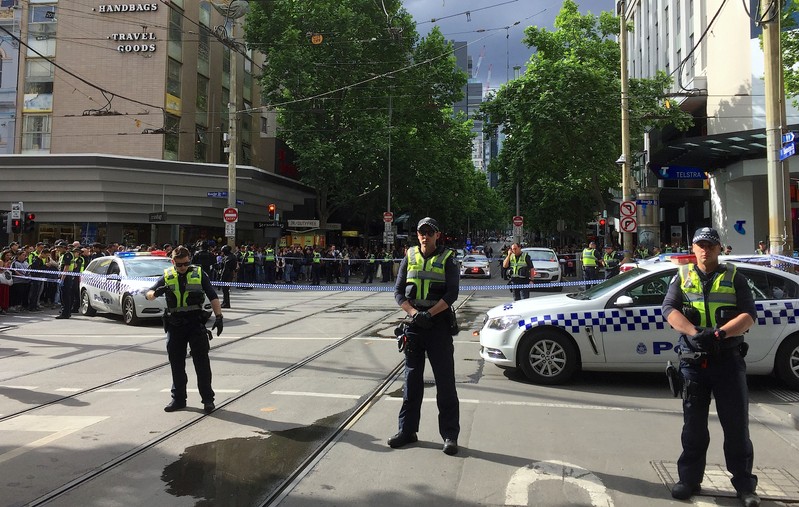 Policemen block members of the public from walking towards the Bourke Street mall in central Melbourne