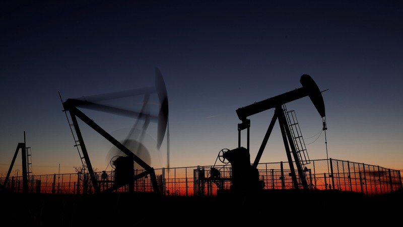 Oil pumps are seen after sunset outside Vaudoy-en-Brie